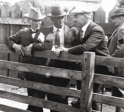 8406823e-906c-4536-a3fc-4e0894949258.jpg; 2304; Four men at an agricultural show; photograph