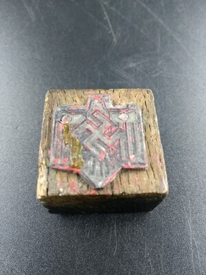 f7c60b15-d921-44ba-b9bf-aacee9644dae.jpg; 2022-0005-HHI; Metalen stempel met hakenkruis op houten blokje.; stempels