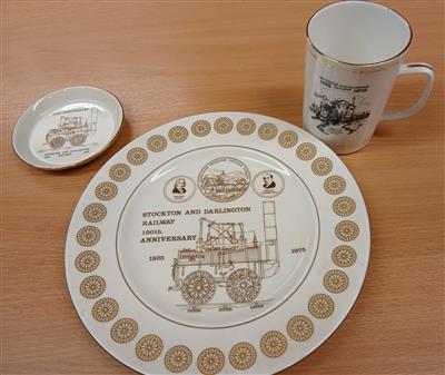 6e687e89-ca22-43b9-8d27-5166b70914a7.jpg; NYMR/2026/5; Mug, plate, small plate commemorating 150 year anniversary of the Stockton and Darlington Railway; Other